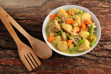 Overhead view-Beef curry on wooden background,
