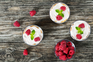 yogurt in cups with  raspberry, whole grain cereals and corn fla