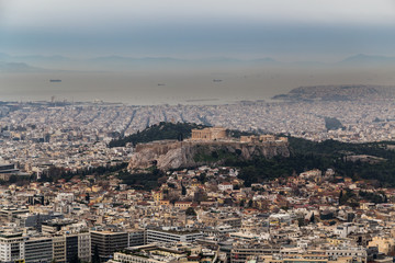 Panoramic view of Acropolis hill and the Parthenon and Athens port in the background on a hazy day