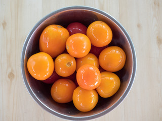 Shiny orange pickled tomatoes