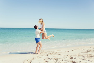 Happy couple  jumping on beach vacations
