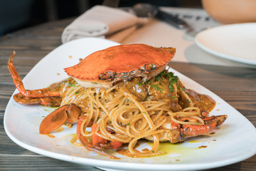 Spaghetti with crab. Italian food, serve in a white plate.
