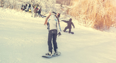 Fototapeta premium girl on snowboard on snowhill