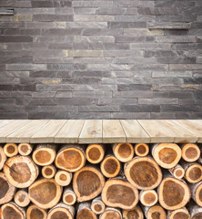 Empty top of wooden table or counter with pile wood log and ston