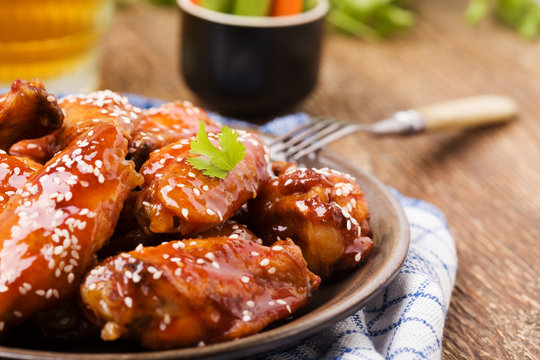 Baked Chicken Wings In Honey Sauce Sprinkled With Sesame Seeds.