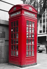 Fototapeta na wymiar Traditional English Red phone box in the street