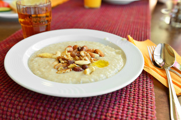 Organic oatmeal porridge with different nuts. Healthy breakfast and diet concept