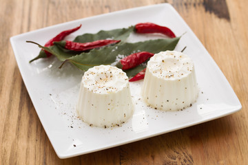 fresh cheese with pepper on white dish
