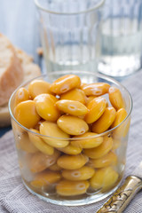 salted lupins in glass with glass of wine