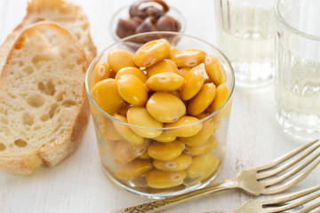 salted lupins in glass with glass of wine