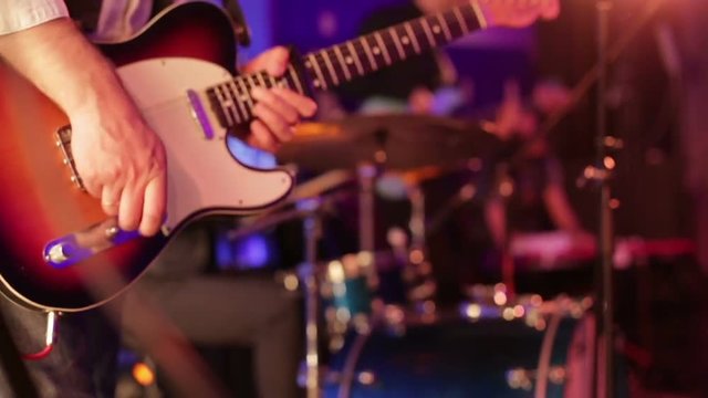 The musician plays the electric guitar