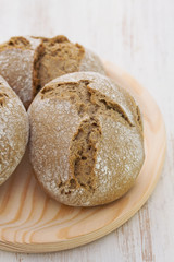 bread on wooden dish on white background