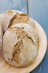 bread on wooden dish on blue background