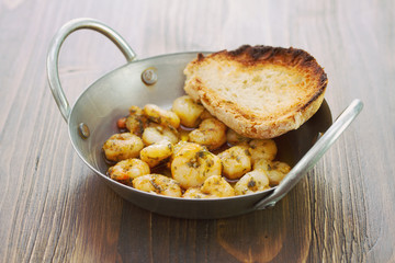 fried shrimps with bread on dish on brown wooden background