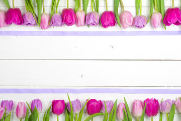Bright, beautiful tulips on a wooden background. Top view. Copy space for text. card with flowers