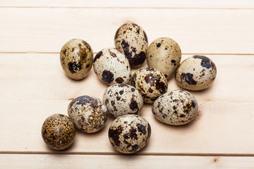 Fototapeta premium Quail eggs on a wooden table