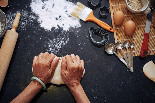 Hands Of Woman Kneading Dough, View From Above