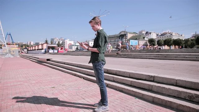 Young tourist man using map on his tablet walking in the city. HD.