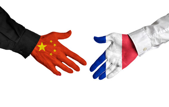China and France leaders shaking hands on a deal agreement