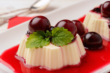 Panna cotta with cherries and cherry sauce. 