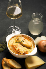 Traditional french onion soup on the black table