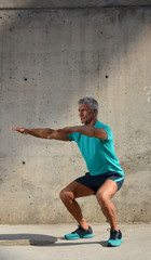 Fototapeta na wymiar Older man practicing stretching