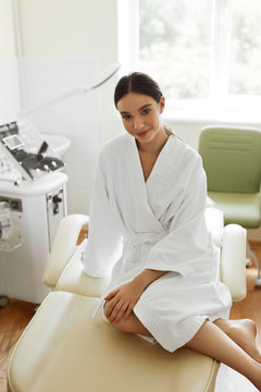 Beautiful Woman In Bathrobe In Cosmetology Room At Spa Salon