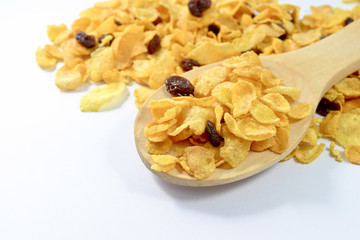 Cornflakes and currant in a wooden spoon