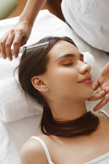 Naklejka premium Hair Care. Beautiful Woman Receiving Brushing Beauty Treatment