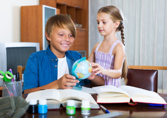 Fototapeta premium Big brother helping little girl