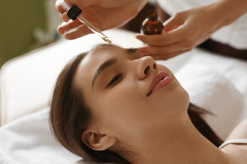 Face Skin Care. Woman Receiving Serum Treatment In Beauty Salon