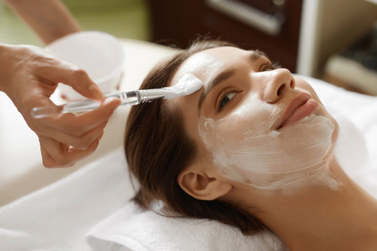 Skin Care. Beautiful Woman Getting Cosmetic Mask At Spa Salon