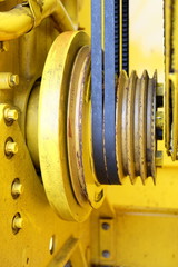 Yellow engine transmission from wedge belts and pulleys drive fan cooler.