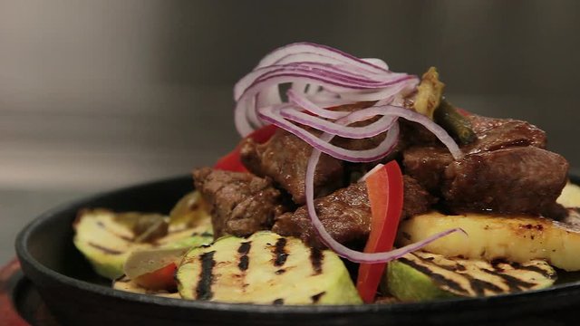Steaming meat dish, close up, sliding