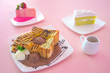 honey toast banana and chocolate on pink table