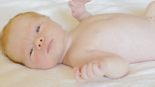
A newborn baby looks and emotes , 5 day