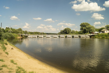 River landscape with bridge on background blue sky