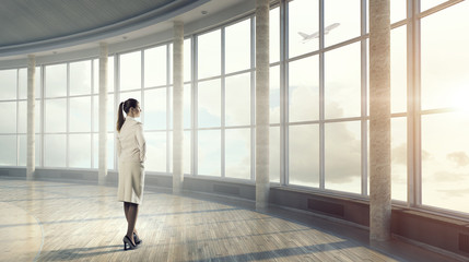 Fototapeta premium Businesswoman in modern office interior . Mixed media