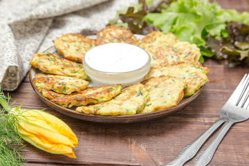 Squash and zucchini fritters with flowers zucchini and herbs