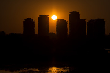 Naklejka premium Sunset over Bucharest city. Sunset over skyscrapers near Vacares