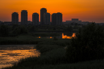 Sunset over skyscrapers. Silhouette panorama at sunset with skyscrapers. Sunset over the Cities Silhouette