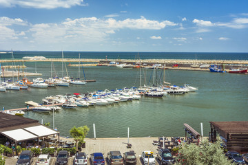 Modern yachts and boats in Touristic Tomis Port at The Black Sea in Constanta, Romania. Tomis port is an important attraction in Constanta city for tourists.