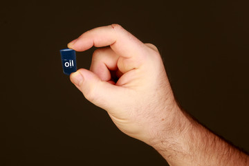 man holds in his hands barrels of oil