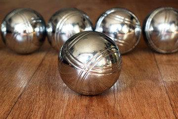 Petanque balls on wooden surface