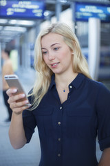 Fototapeta premium Woman at platform using her phone