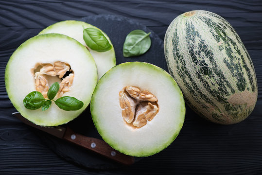 Whole and sliced ripe melons, above view