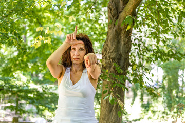 mature woman making loser sign