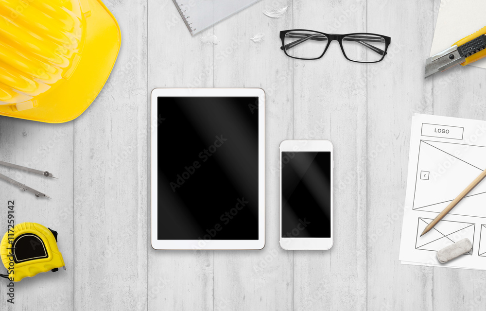 Poster tablet and smart phone on designer desk. mockup for responsive web site promotion.
