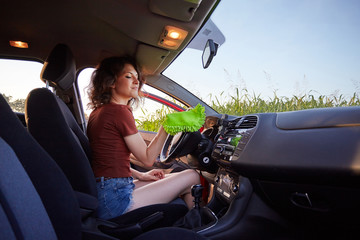 woman with microfiber cloth cleaning car