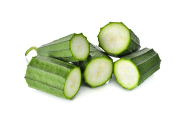 portion cut Fresh Angled luffa on white background